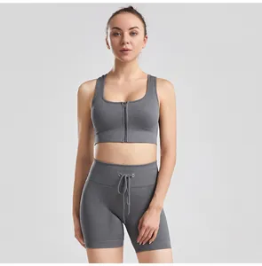 Full view of a model wearing a grey ribbed yoga set with a zip-front sports bra