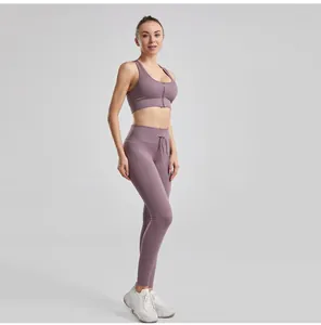 Full-length view of a ribbed purple yoga set with drawstring leggings and zip-front bra