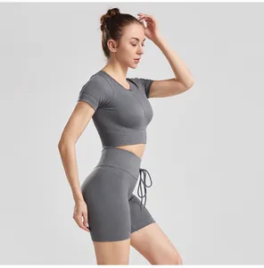 Side view of a gray ribbed yoga set featuring drawstring shorts and a zip-up crop top.