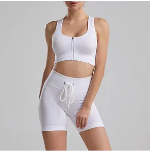 Detail of white ribbed yoga set featuring front zip bra and drawstring shorts