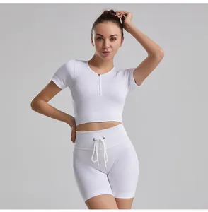 Detail shot of white ribbed seamless yoga set featuring a crop top and drawstring shorts.