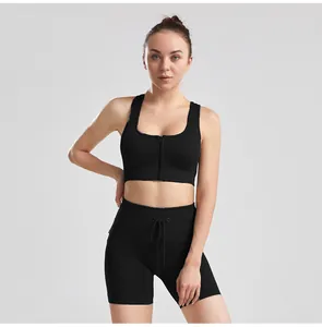 Close-up of black ribbed yoga outfit featuring zipper sports bra and drawstring shorts