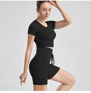 Side view detail of women's black ribbed short sleeve yoga set with drawstring shorts