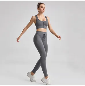 Full view of grey ribbed yoga set with front-zip bra and drawstring leggings