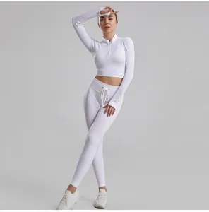 White ribbed two-piece yoga set with long sleeve zipper top and high waist drawstring leggings