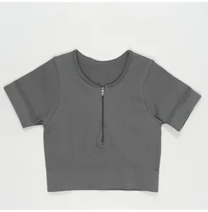 Grey ribbed yoga crop top featuring a front half-zipper and seamless design