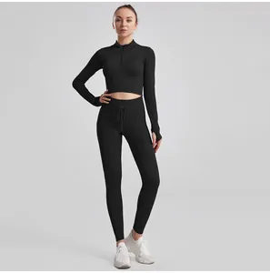 Black ribbed seamless yoga set for women with long sleeve crop top and drawstring leggings