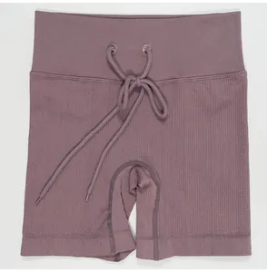 Close-up detail of mauve ribbed drawstring yoga shorts with high-waisted seamless texture
