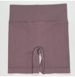 Close-up of mauve high-waist ribbed yoga shorts with seamless butt-lifting fabric texture