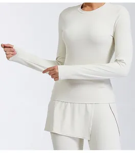 Detail of breathable cream long-sleeve yoga top showing tight fit and smooth fabric