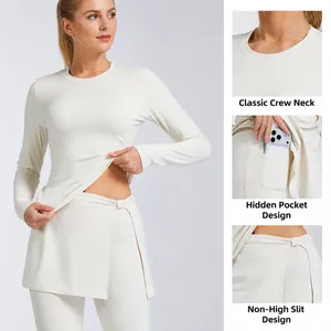 Athletic cream long sleeve yoga set featuring high-slit skirt leggings and hidden side pocket