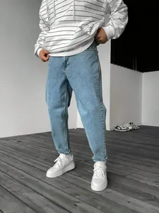 Jean en denim bleu clair pour homme, coupe droite décontractée, avec baskets blanches
