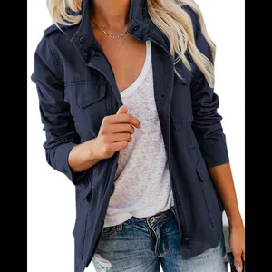 Detail view of a navy blue utility jacket with multiple functional pockets and zipper