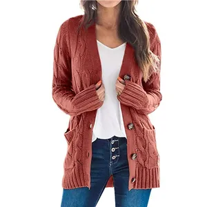 Rust orange mid-length cable knit cardigan with buttons and pockets for women.