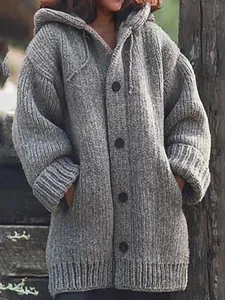 Macro view of a chunky grey knit hooded cardigan for women with black buttons