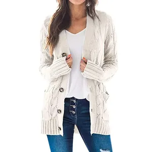 Woman wearing a long-sleeved cable knit cardigan in cream with large buttons