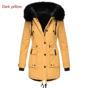 Close-up detail of a dark yellow women's winter parka with a large black faux fur collar