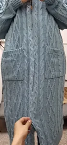 Detailed macro view showing the thick cable-knit texture of this blue women's cardigan