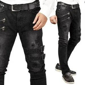 Detailed view of black men's biker skinny jeans with decorative zippers and buckles