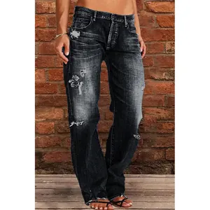 Distressed dark wash women's flare jeans with ripped details on brick background.