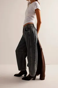 Detailed side view of women's vintage washed dark blue wide-leg loose denim jeans