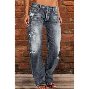 Detailed macro view of women's grey distressed washed jeans with ripped accents