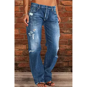 Detailed view of women's blue distressed denim jeans showing ripped wash effects.