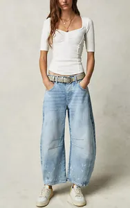 Full-length view of women's loose wide-leg washed denim jeans in light blue.