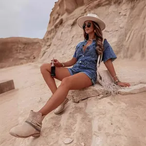 Vintage style denim romper jumpsuit shorts for women, retro fashion in desert setting