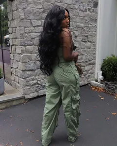 Side view of woman in olive green strapless cargo jumpsuit with multi-pockets