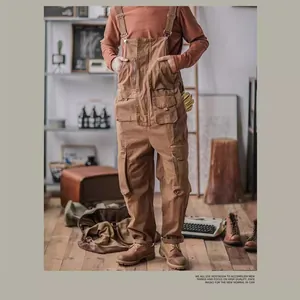 Retro style men's loose brown cargo bib trousers shown in a vintage rustic studio setting