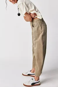Side profile view of women's loose-fit wide-leg washed denim trousers in a vintage khaki hue