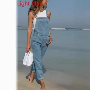 Stylish women's light blue denim overalls jumpsuit featuring a casual seaside beach look