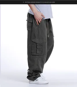 Side view detail of men's loose fit multi-pocket hip-hop style cargo pants in dark grey