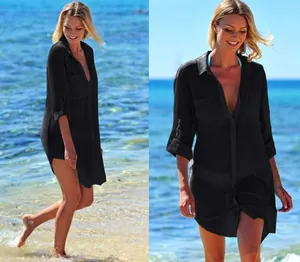 Close-up of black crinkle cloth beach cover-up shirt with two pockets and hidden buttons