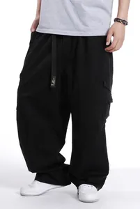Detailed view of men's black oversized cargo pants with wide leg and pockets