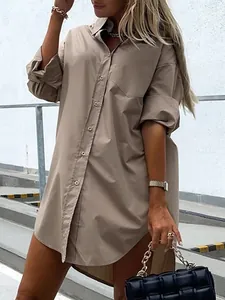 Chic oversized khaki cotton button-down long shirt for women in outdoor setting