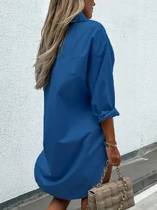 Back view of a comfortable long-sleeved blue cotton shirt dress with a relaxed loose fit