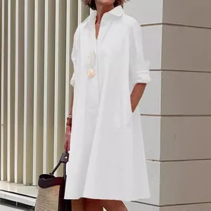 Elegant white cotton linen long sleeve button down midi shirt dress for women in a loose fit.