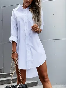Detailed shot of a white cotton oversized long-sleeve button-down shirt dress for women.