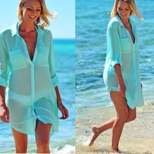Mint green beach cover-up shirt shown from front and side views on a sunny beach