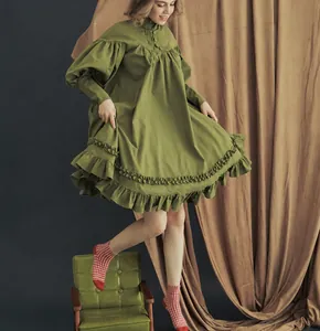 Full view of the green Victorian style ruffled mini dress with puffy long sleeves