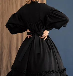 Back view of black Japanese maid dress with a large waist bow and ruffled hem