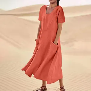 Close-up of lightweight orange linen summer dress featuring functional pockets in desert sun