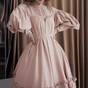 Vintage pink puff sleeve dress featuring a Victorian maid style with elegant ruffled hem