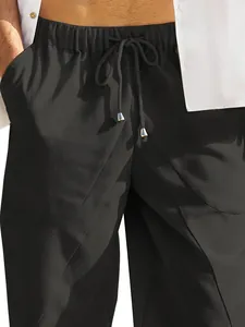 Detailed view of black cotton linen beach shorts with elastic waist and pockets
