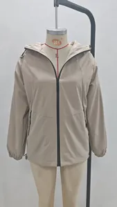 Front view of a beige lightweight hooded windbreaker jacket displayed on a mannequin.