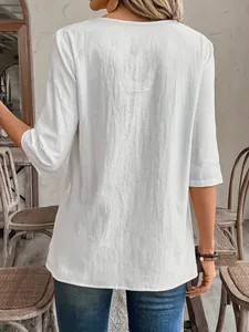 Back view of a white casual three-quarter sleeve blouse with textured fabric detail