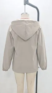 Back view of a lightweight beige hooded windbreaker jacket for women's outdoor wear