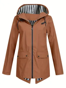 Detailed view of women's brown lightweight outdoor windbreaker with striped hood lining